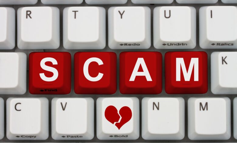 Dating scams on the internet, A close-up of a keyboard with red highlighted text Scam